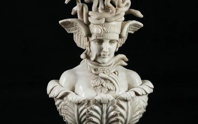 A white marble bust of Medusa