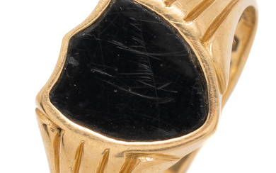 AN ANTIQUE 18CT GOLD ONYX SIGNET RING; featuring a shield...