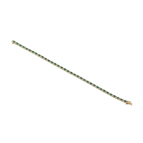 AN EMERALD AND DIAMOND LINE BRACELET, mounted in 14ct yellow...