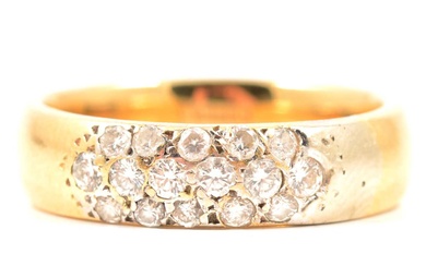 An 18 carat yellow gold band set with diamonds.