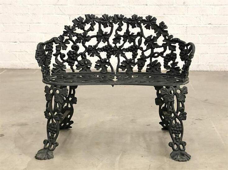 An English black painted cast iron garden bench