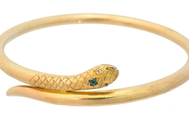 An early 20th century gold emerald and diamond snake bangle
