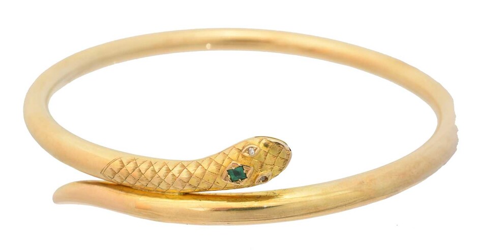 An early 20th century gold emerald and diamond snake bangle