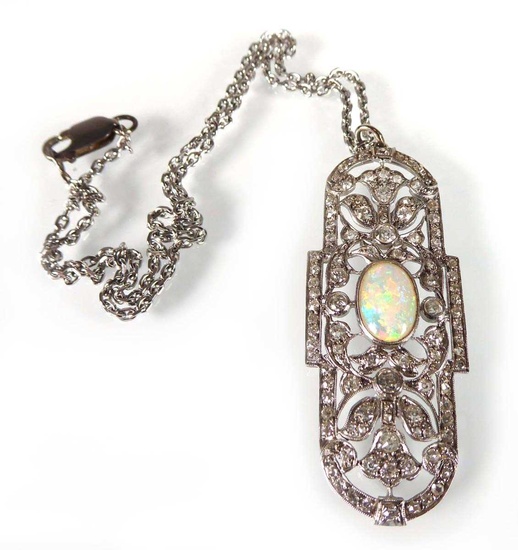 An early 20th century white metal pendant set oval opal...