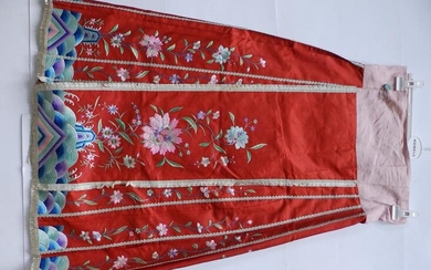 An early 20thC Chinese red silk skirt embroidered in...