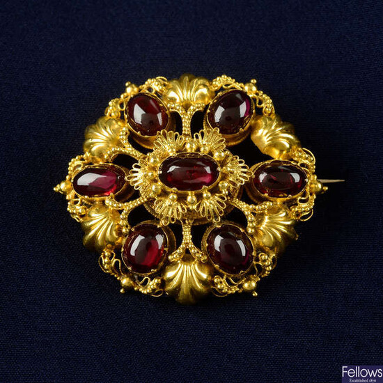 An early to mid 19th century gold foil back garnet cannetille brooch, with locket reverse.