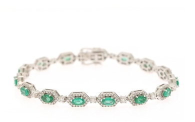 An emerald and diamond bracelet set with numerous oval-cut emeralds encircled by numerous brilliant-cut diamonds, mounted in 18k white gold. L. app. 17.8 cm.