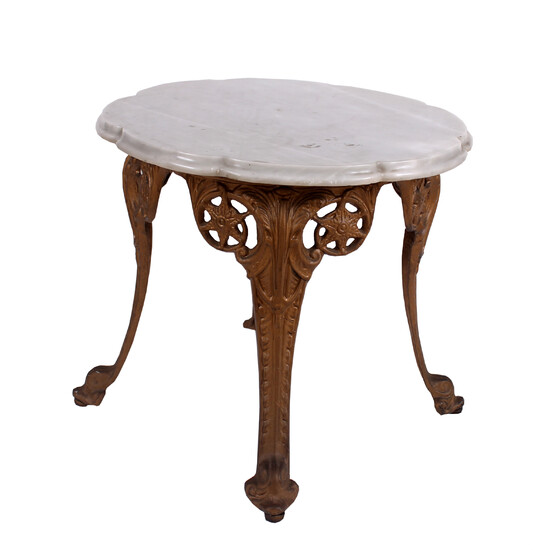 An iron cast low table with marble top