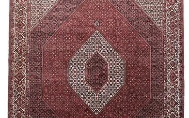A Persian Bidjar carpet, classic medallion design surrounded with Herati pattern on red base. 20th century. 293×251 cm.