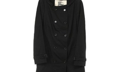 Burberry: A black coat with black buttons, two pockets, a open slit on the back and a belt. Approx. size 40.