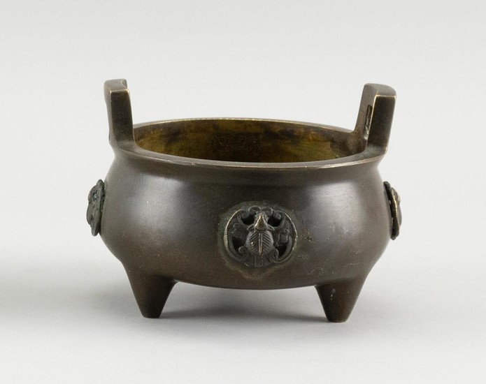 CHINESE BRONZE CENSER Ovoid, with rectangular handles, relief bat design on body and a tripod base. Four-character hallmark on under...
