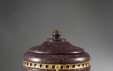 Covered mortar in Egyptian porphyry, it rests on a tripod base, bronzes with sphinxes on a white marble base (restored), it is decorated with an openwork frieze and the socket decorated with a finial.