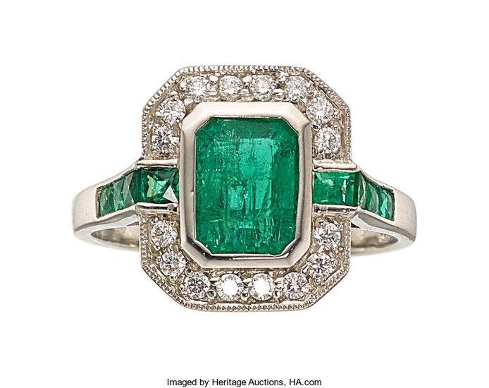 Emerald, Diamond, Platinum Ring The ring features an...