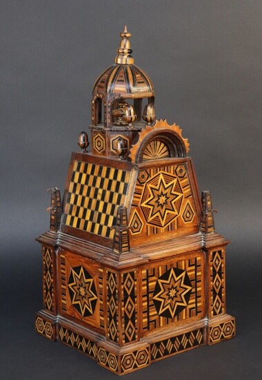 Flower of work of cabinetmaker in marquetry representing a temple of square plan surrounded by bells and surmounted by a finial. Differentiated decoration on each side. Alsace ? Height 57 cm. Accidents and missing parts