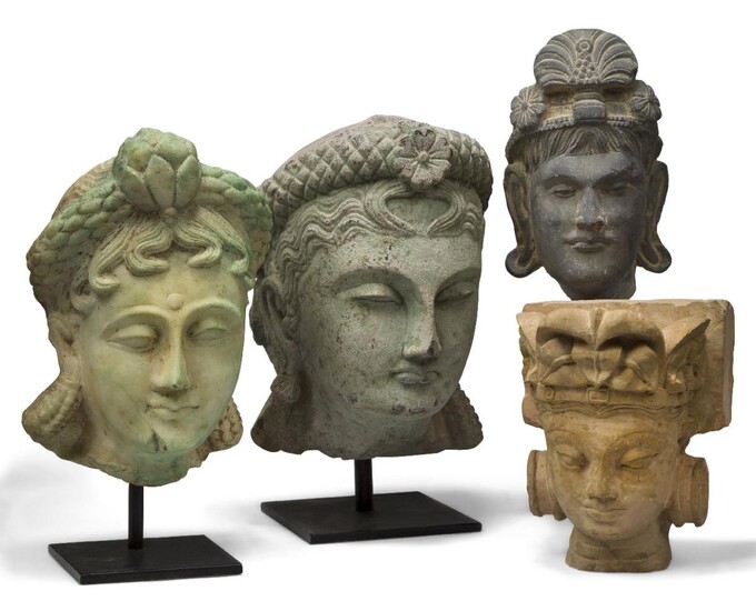 Four South East Asian carved marble and stone busts of female deities, 20th century, three on modern metal stands, 28cm, 27cm, 23cm and 16cm high overall (4)