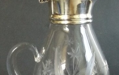 Hand cut glass cruet with silver base and lid