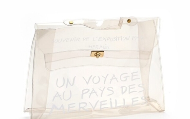 NOT SOLD. Hermès: A "Kelly Souvenir" bag made of transparent vinyl with white text on...