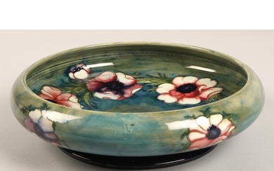 Moorcroft shallow pottery bowl in the anemone pattern on blu...