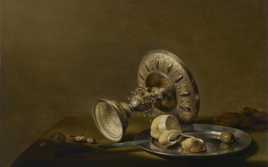 PIETER CLAESZ (BERCHEM 1597/8-1660/1 HAARLEM) An overturned silver tazza, a partly peeled lemon and an olive on a silver plate, walnuts, hazelnuts and a knife on a draped table