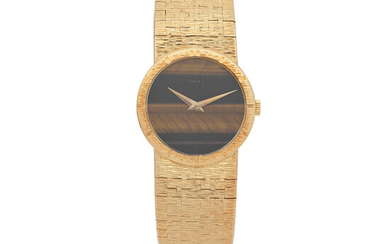 Piaget. A lady's 18K gold manual wind bracelet watch with tiger's eye dial Ref 9701 A6, Circa 1980