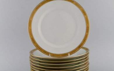 Royal Copenhagen service no. 607. Twelve porcelain dinner plates. Gold border with foliage. Model