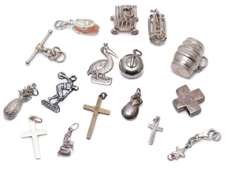 SIXTEEN SILVER CHARMS/PENDANTS; including a curling ball, wine barrel, a carriage, caged bird, a pelican, a Discobolus of Myron, a p...