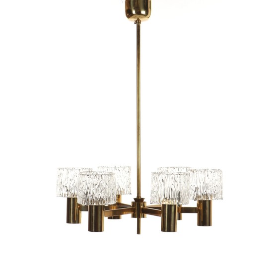 Scandinavian design: A brass chandelier, six branches with glass shades. 1970s. H. 75. Diam. 55 cm.