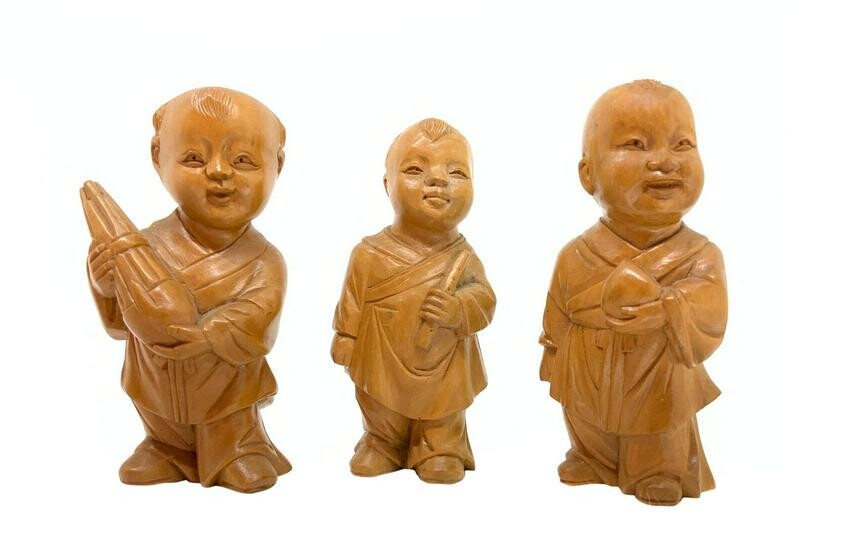 Sculptures of three Chinese children in maple wood