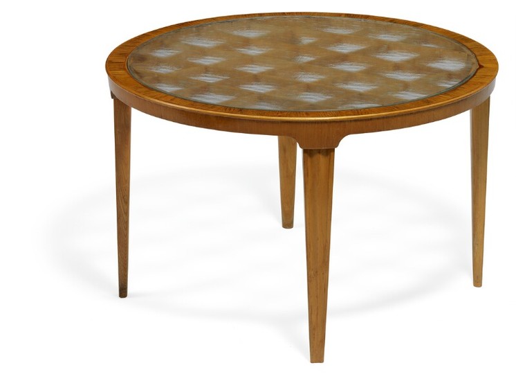 Swedish design: Coffee table with profiled, tapering elm wood legs. Circular top of raw glass with wooden grate below.