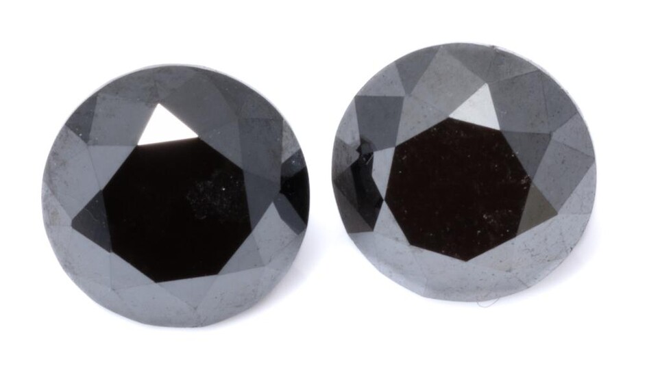 TWO UNSET ROUND BRILLIANT CUT BLACK DIAMONDS; 2.42ct (7.64 x 6.15mm) & 2.24ct (7.71 x 5.58mm) treated stones.