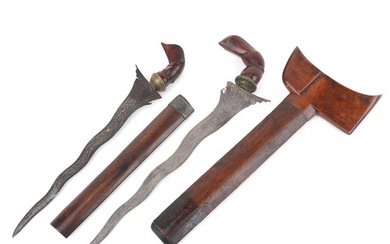 Two Javanese Kris daggers with hardwood sheaths, handles and...