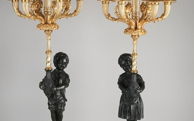 Two large bronze and marble candlesticks, with gilding