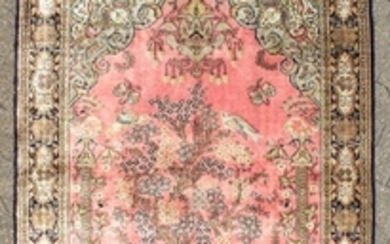 A FINE PERSIAN SILK QUM RUG with a tree pattern and