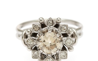 A daimond ring set with an old-cut diamond, app. 0.90 ct., encircled by numerous old-cut, single-cut and brilliant-cut diamonds, mounted in 18k white gold.