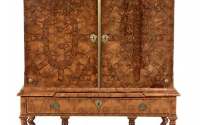 A Charles II walnut and olivewood oyster veneered cabinet on stand