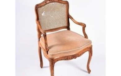 A Louis XV style French carved walnut armchair