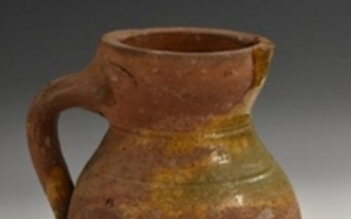 A post-Medieval green ware terracotta baluster ale jug