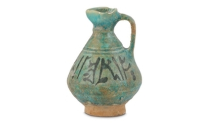 A TURQUOISE-GLAZED POTTERY JUG WITH PSEUDO-KUFIC INSCRIPTION Central...