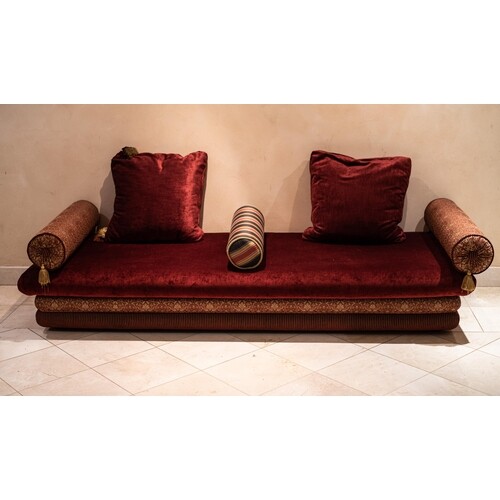 26. AN UPHOLSTERED DAYBED Accompanied by three bolster and ...