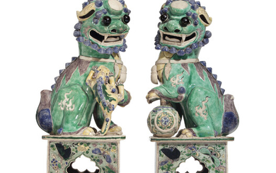 A PAIR OF FAMILLE VERTE BISCUIT-GLAZED BUDDHIST LIONS, KANGXI PERIOD (1662-1722)