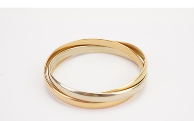A 18ct gold tri gold bangle. White, yellow and rose coloured...