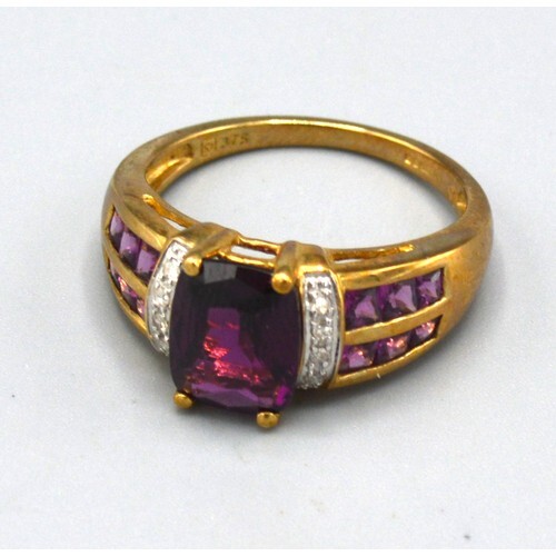 A 9ct. Gold Amethyst and Diamond Set Ring with a central ame...