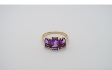 A 9ct yellow gold three stone amethyst ring, amethysts are a...