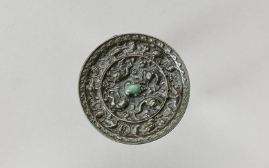 A BRONZE 'LION AND GRAPEVINE' MIRROR, FIVE DYNASTIES