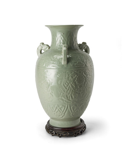 A CHINESE CELADON GLAZED VASE IN CARVED RELIEF