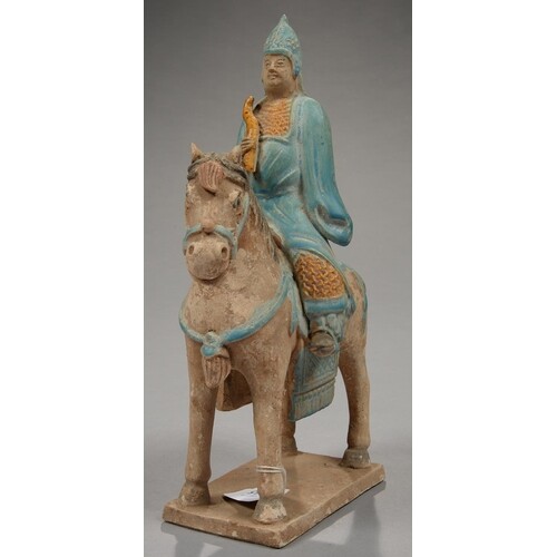 A CHINESE POTTERY FIGURE FUNERARY OF A MOUNTED ARCHER IN HAN...