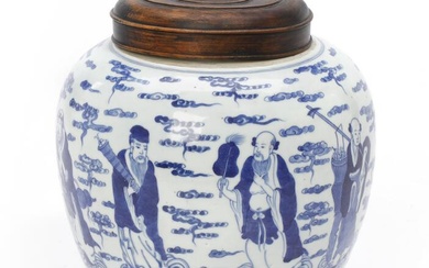 A Chinese blue and white “Eight Immortals” porcelain jar with wooden cover....
