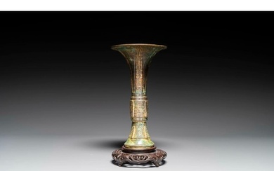 A Chinese bronze Shang-style 'gu' vase on wooden stand, 19/2...