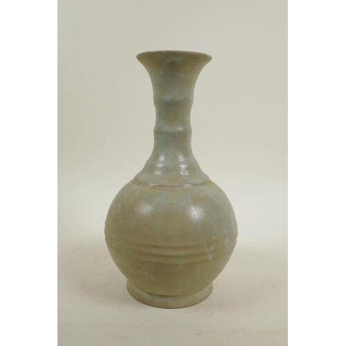A Chinese celadon glazed pottery ring turned vase in the Son...