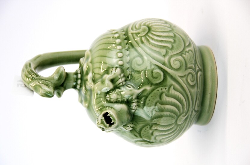 A Chinese incised and celadon glazed porcelain mystery teapot, H. 18.5cm.
